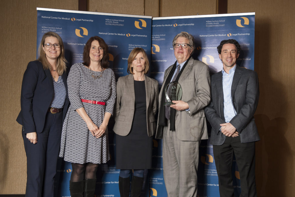 Randall Mark, Chief of Staff to the President and CEO, accepting the 2016 MLP Leadership Award on behalf of NYC Health + Hospitals. Also pictured: Randye Retkin from LegalHealth (center) and staff from the National Center for Medical-Legal Partnership.